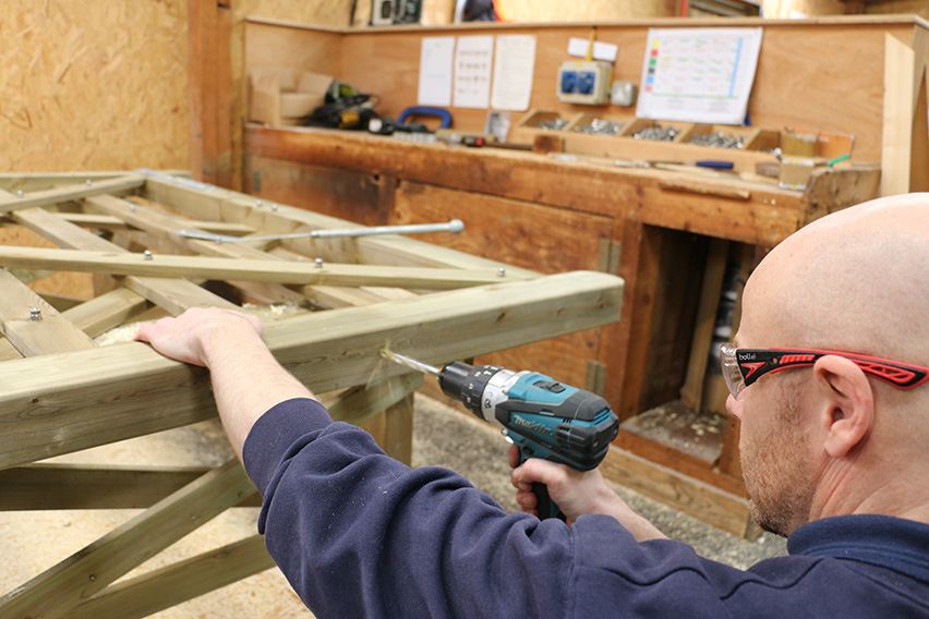 Once you’ve lined up the handle and made sure the bracket is in the middle of the wood, drill out the hole.