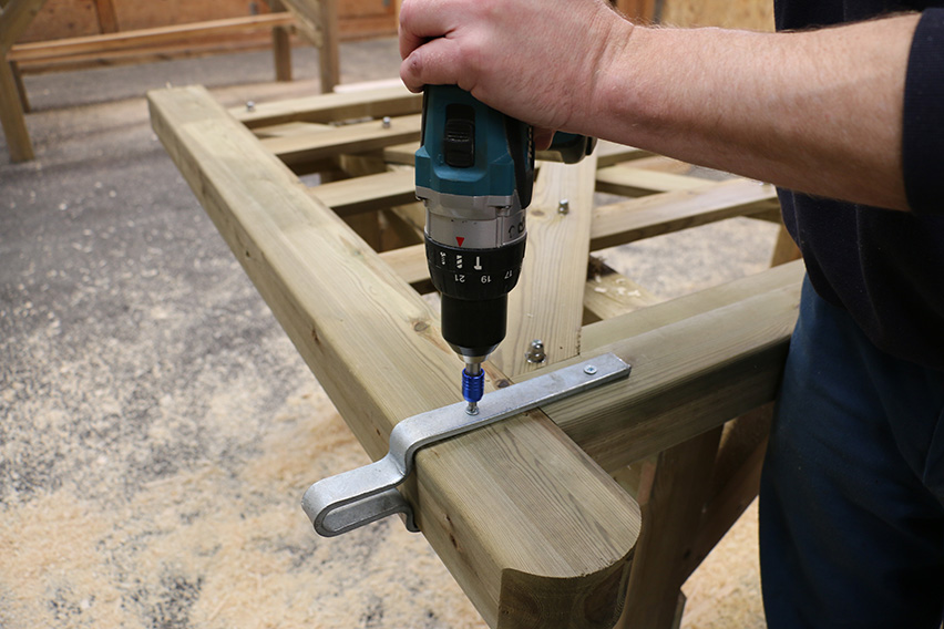 Carefully drill two holes for the bolts that attach the gate latch.