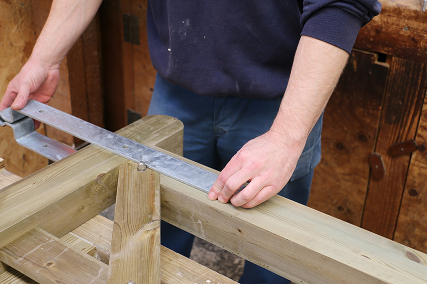 Slide the band onto the top panel of the gate.