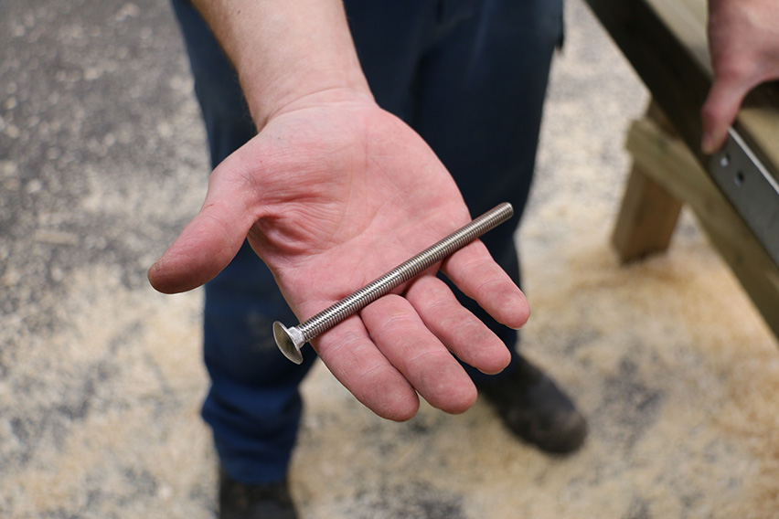 Make sure the metal work is straight and pass this M8 120 mm bolt into the hole closest to the top of the gate.