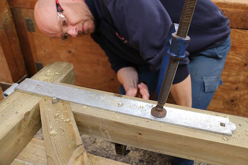 The use of a hammer ensures the bolt passes right through and stands proud of the wood.